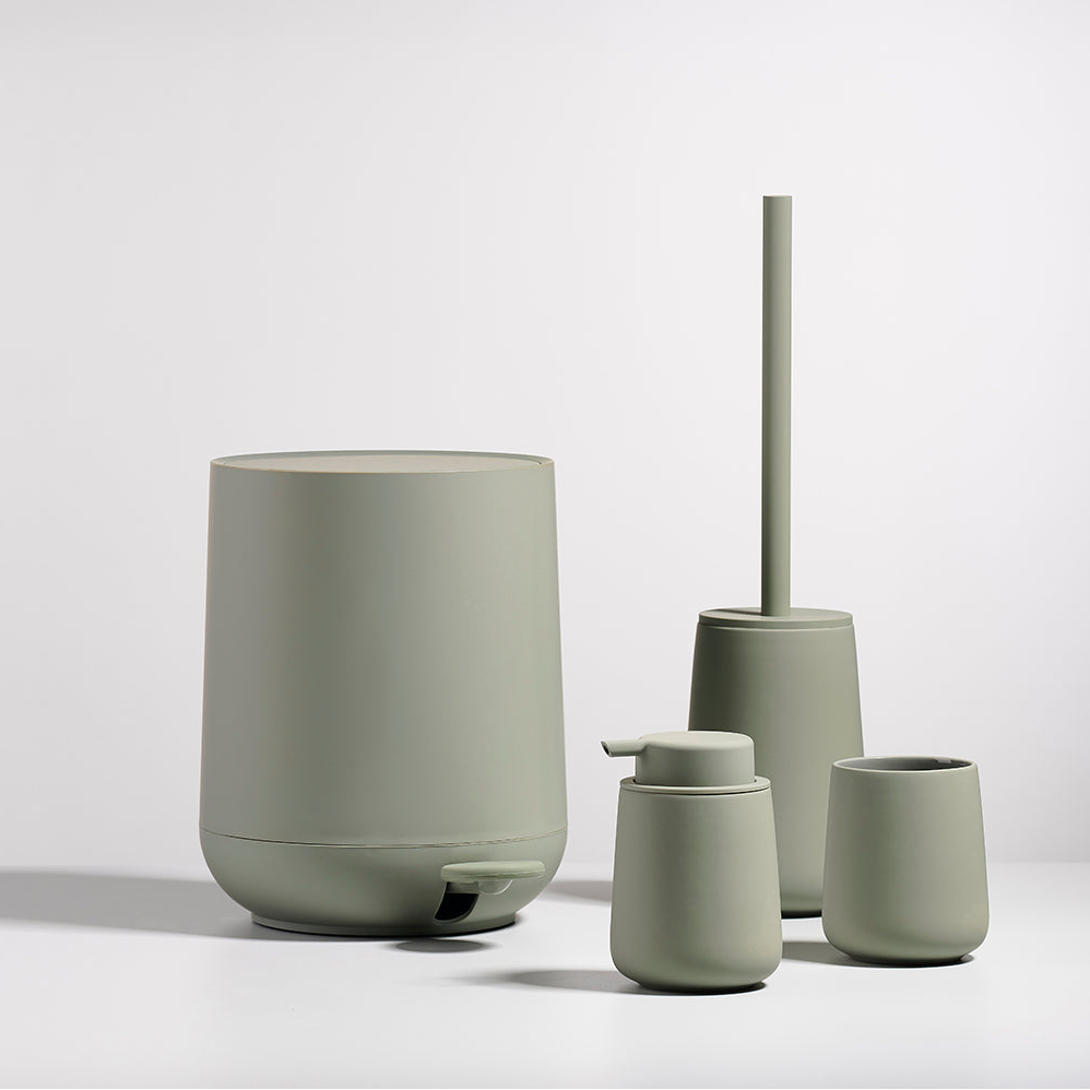 Toalettbørste i grønn tone som gir badet et rolig uttrykk