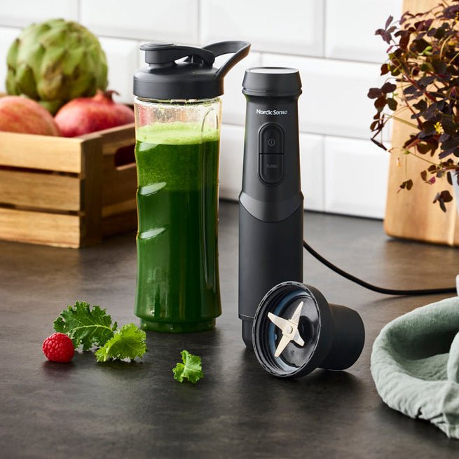 Sort stavmikser brukt til grønne smoothies på kjøkkenet