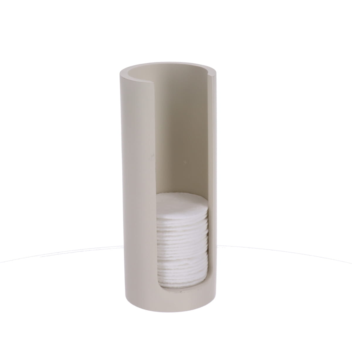 Beige bomullspad-dispenser stylet på en baderomshylle