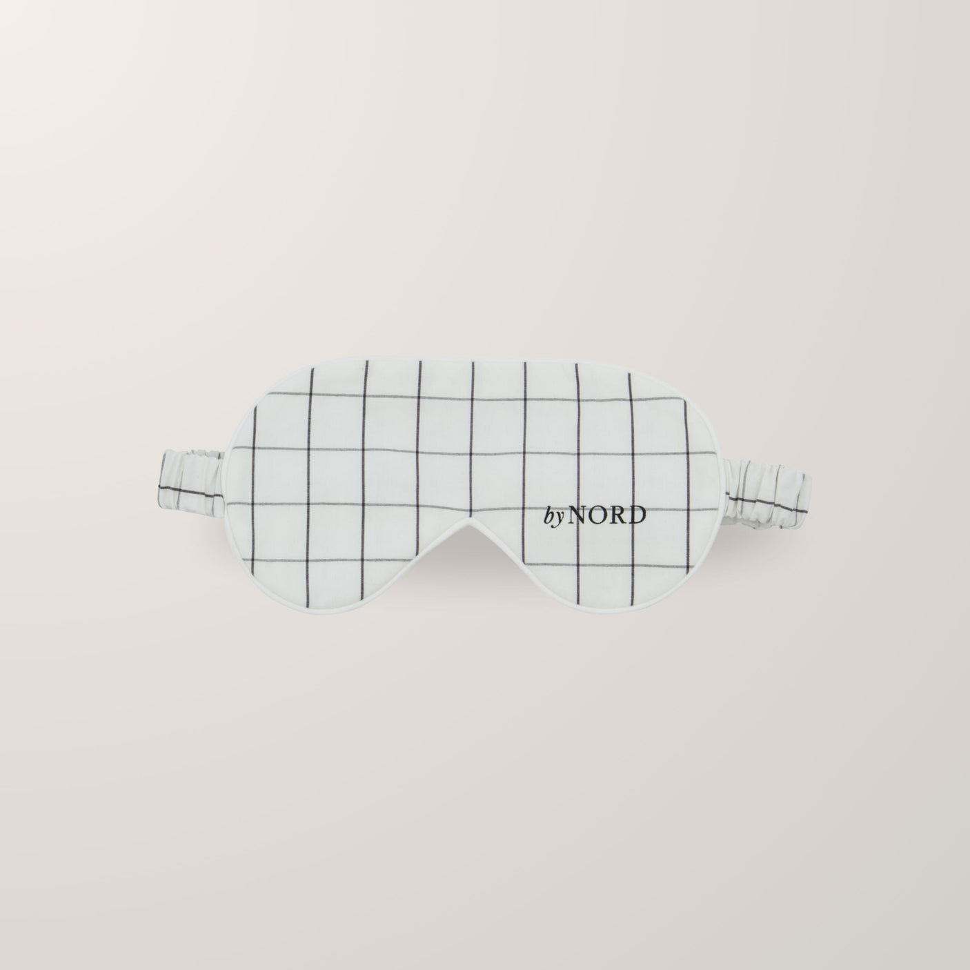 Søvemaske med ruter og elastisk stropp.