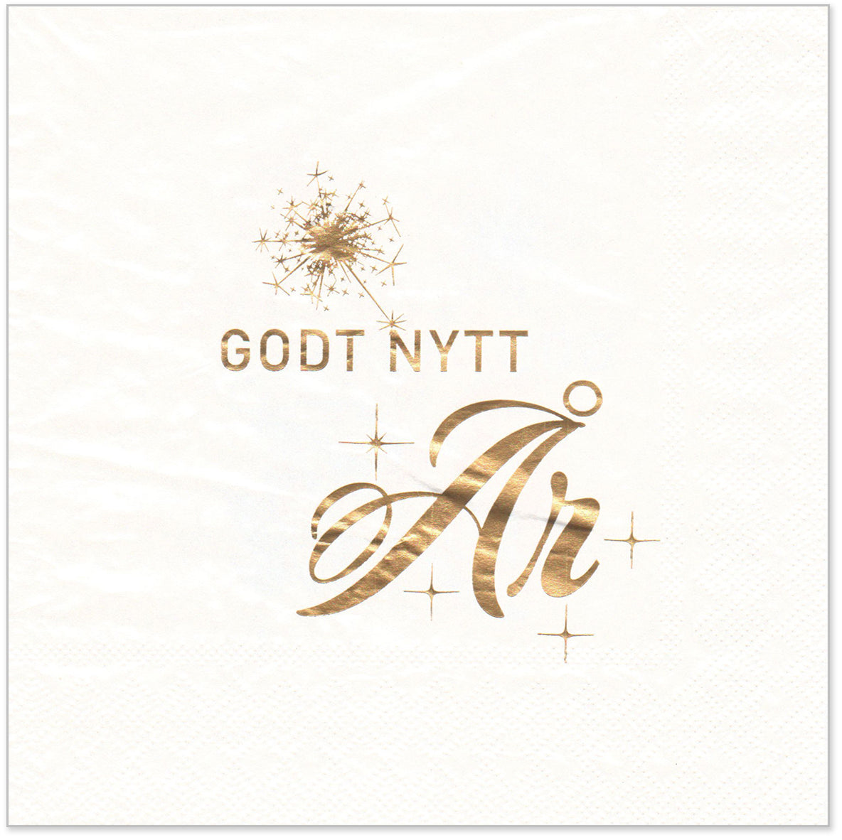 Hvit papirserviett med gulltekst "Godt Nytt År" og dekorative stjerner.