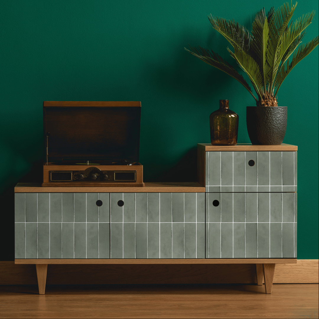 Kreativ bruk av grønne selvklebende fliser på skjenk i stue med mørk grønn vegg og dekor.