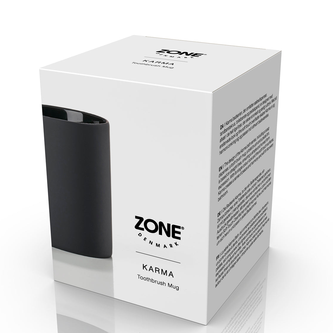 Karma tannbørsteholder i matt sort steintøy vist sammen med emballasje