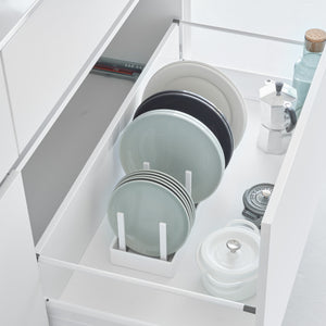 Hvit justerbar gryte- og lokkholder med skillevegger i kjøkkenskuff.