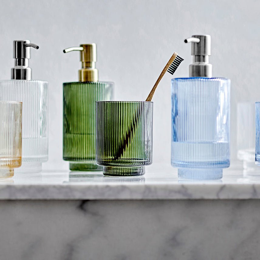 Clarity såpedispenser i mørkegrønt glass ved servant