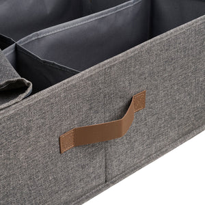 Nærbilde av brunt PU-håndtak på mørk grå tekstilkurv