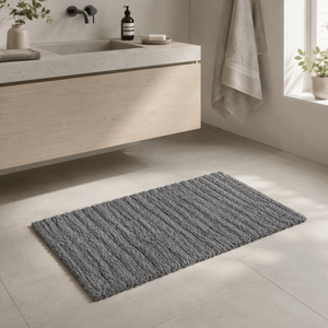 Grå Zone Denmark Tiles baderomsmatte foran en servant i et lyst, moderne baderom. - Lindas dekor