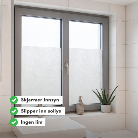 Statisk vindusfolie med blader montert på glassdør – moderne design