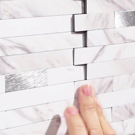 Elegant backsplash i marmorlook montert bak kjøkkenbenk.