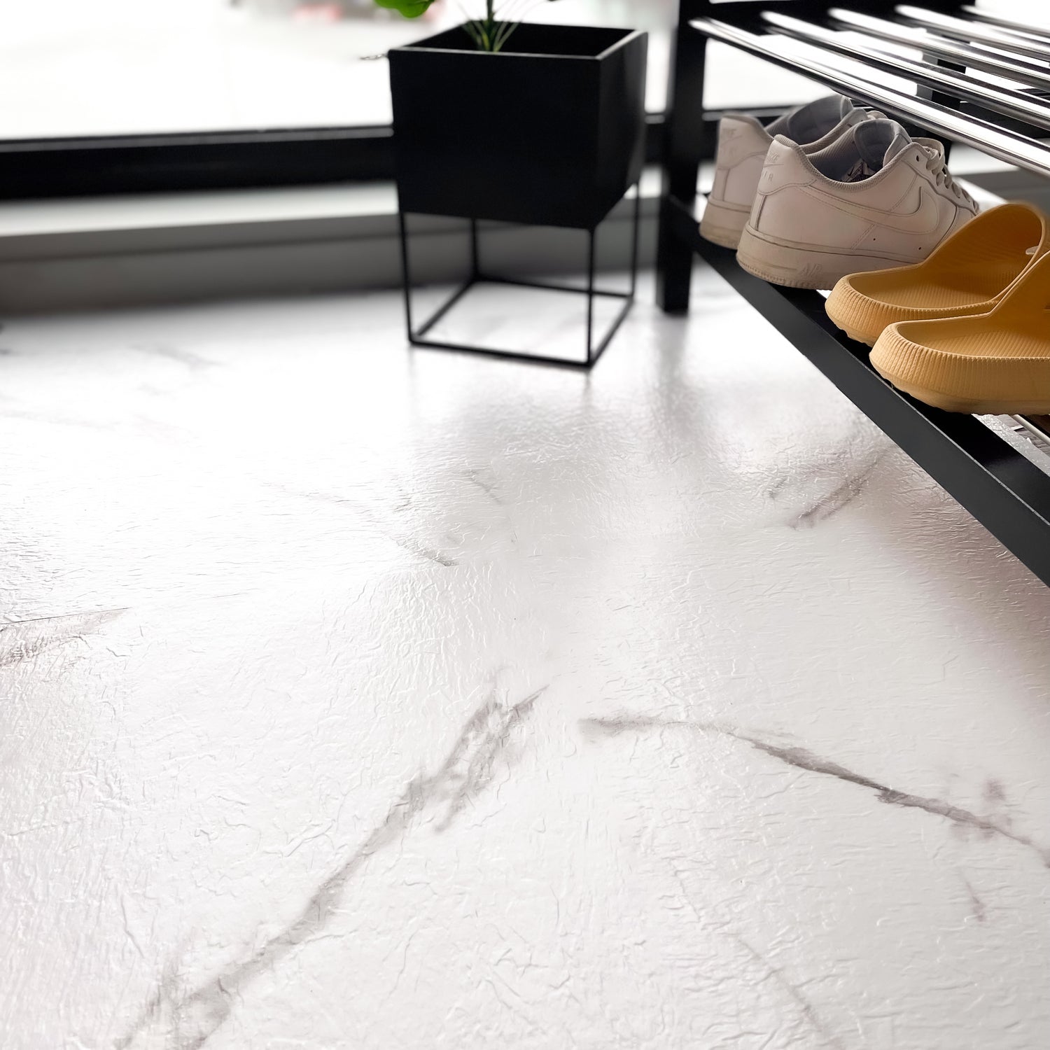 Detaljbilde av hvit marmor gulvfliser med grå marmorering og naturlig struktur"

